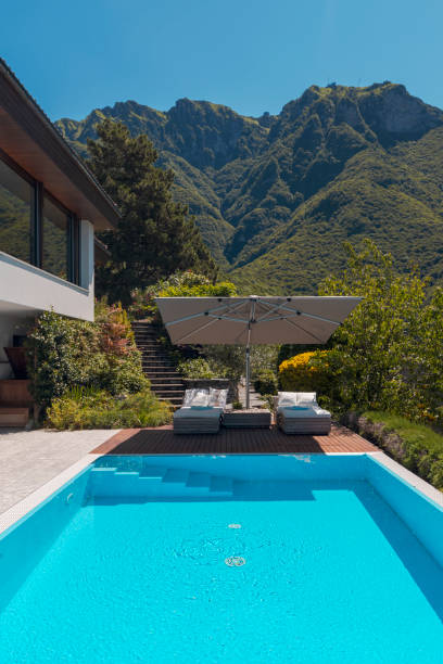 istock Modern two-story house with large pool overlooking the mountains. Nobody inside 1328520883