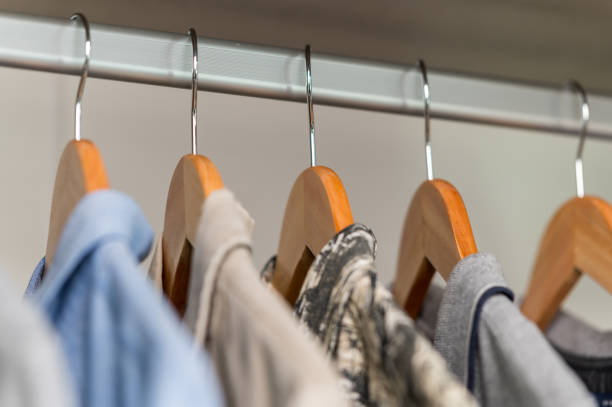 istock close up collection Hangers with clothes on rack in wardrobe 1328521284