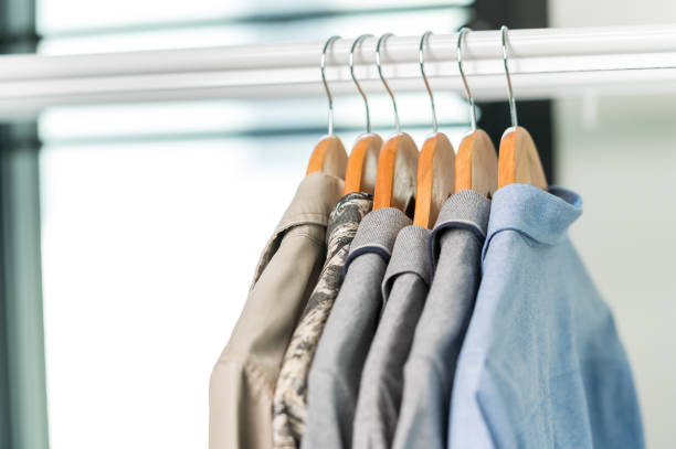 istock close up collection Hangers with clothes on rack in wardrobe 1328521290