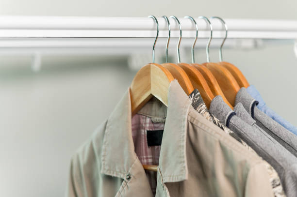 istock close up collection Hangers with clothes on rack in wardrobe 1328521297