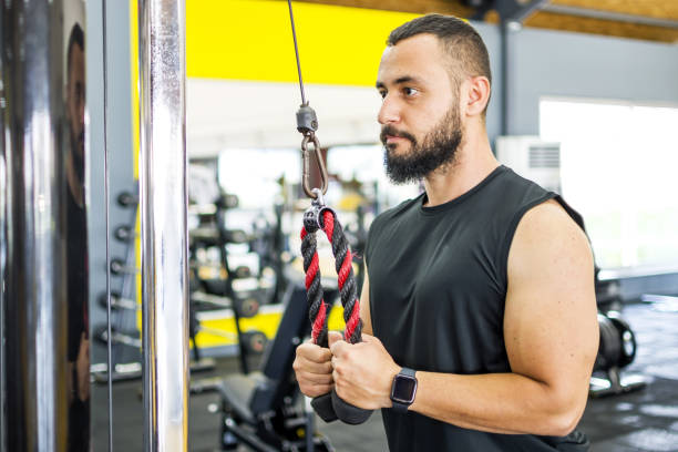 istock Muscular bodybuilder guy doing exercises in gym 1328522494