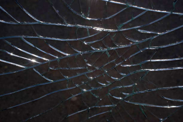 istock Broken glass over natural black background 1328523703