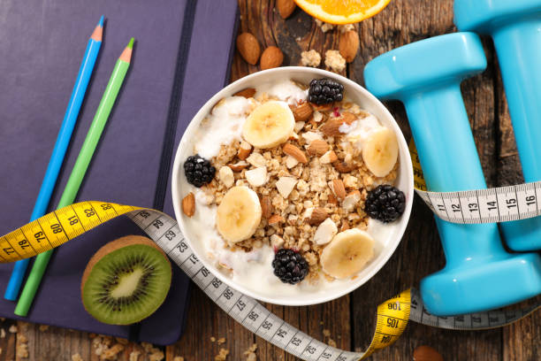 istock diet food concept with muesli and dumbbell 1328523841