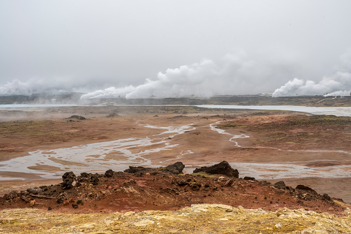 Boiling Mud Pots in the Iceland Volcanically Active Zone and Smoking Cracks in the Ground Around. Location: Geothermal Area Hverir, Myvatn Region, North Part of Iceland, Europe. High quality photo