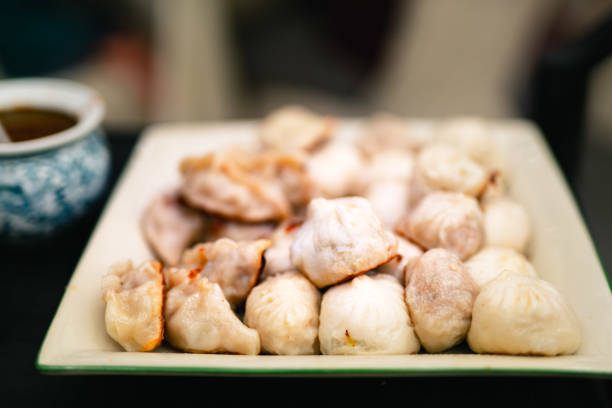 Fresh boiled vegan dumplings . Chinese food on rustic old vintage  background