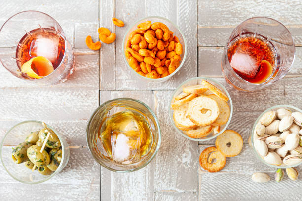 Alcoholic drinks and salty snacks stock photo