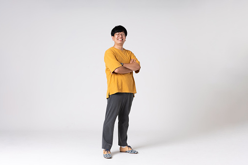 Full-length portrait of an Asian man on a white background.\nFull body shot. Japanese male, 30s.\nHealthy and confident figure.\nsmiling. Looking at camera. Standing.\nShot in a studio with a white background.\nHorizontal shot.