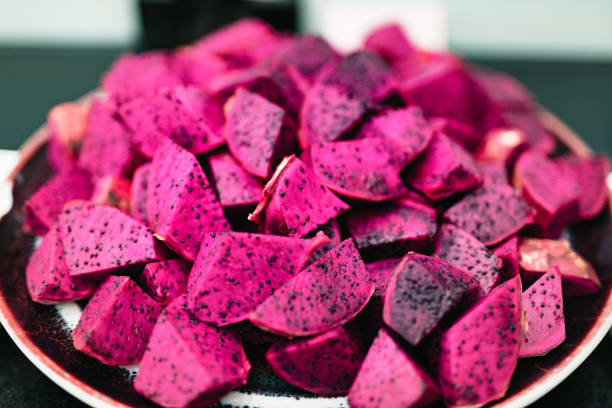 Red Dragon fruit (Pitaya) cut pieces, on the plate stock photo