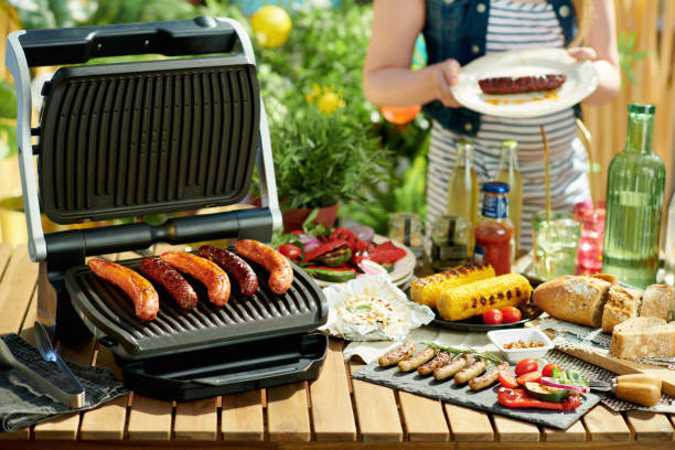 istock desk with electric grill and grilled sausages 1328528257