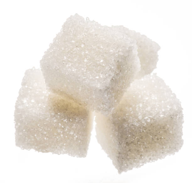 istock White sugar cubes on white background. Macro picture. 1328528346