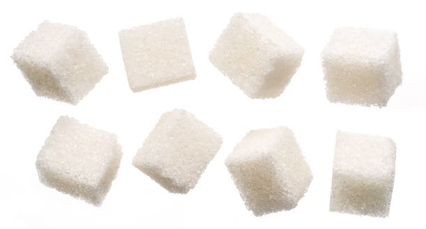 istock White sugar cubes on white background. Macro picture. 1328528347