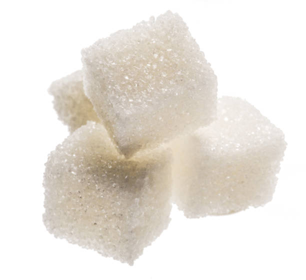 istock White sugar cubes on white background. Macro picture. 1328528359