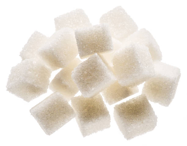 istock White sugar cubes on white background. Macro picture. 1328528420