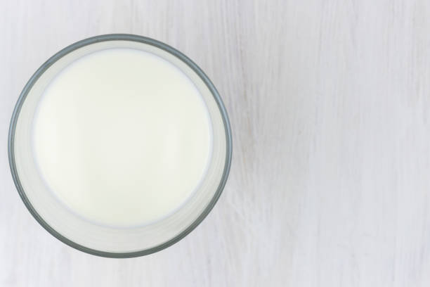 istock Glass of milk on a white wooden table 1328530962