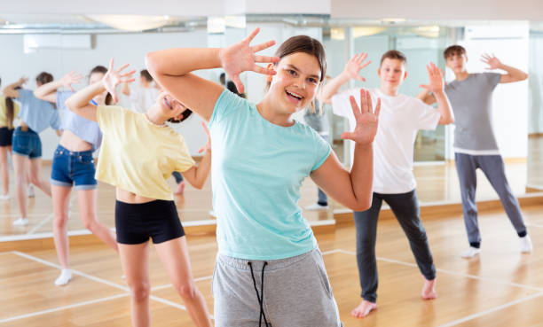 istock Teenage girl exercising during group dance class 1328531014