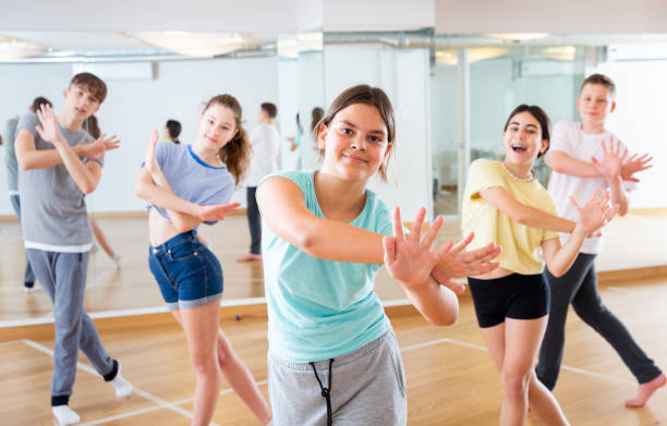 istock Teenage girl exercising during group dance class 1328531024