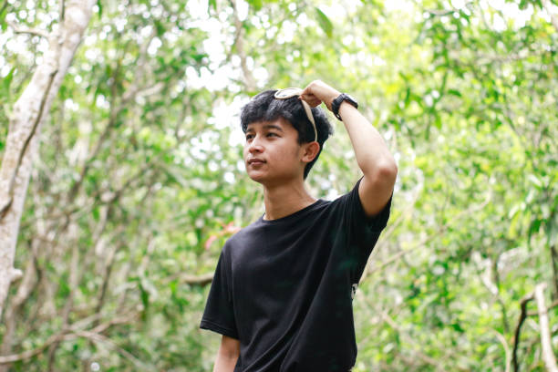 istock Portrait of a young man at park 1328533865