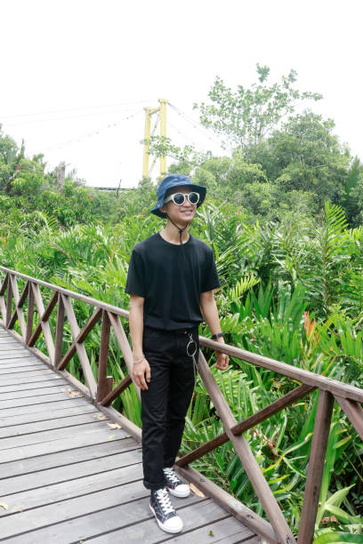 istock Portrait of a young man standing at park 1328534214