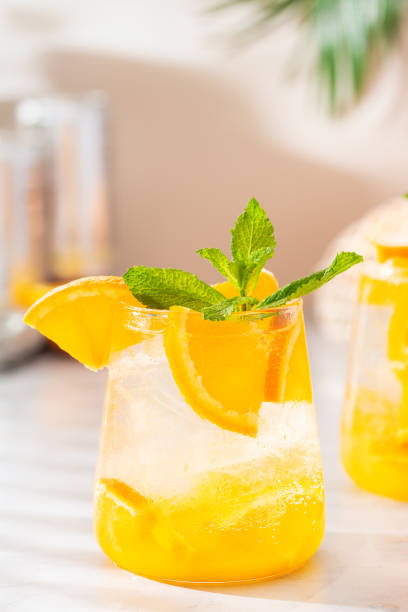 istock Summer refreshing orange hard seltzer cocktail with shadows 1328535831