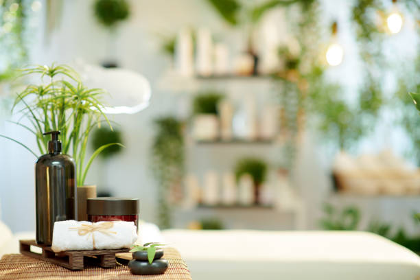 towel, hot stone massage and cosmetics in modern beauty studio