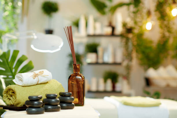istock towels, hot stone massage, essential oils and massage table 1328536058