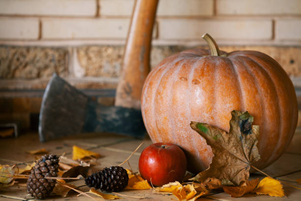 istock Round pumpkin and apple lie on shelf 1328543023
