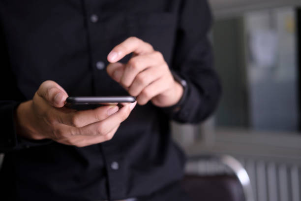 istock Close up of man using mobile phone. 1328543164