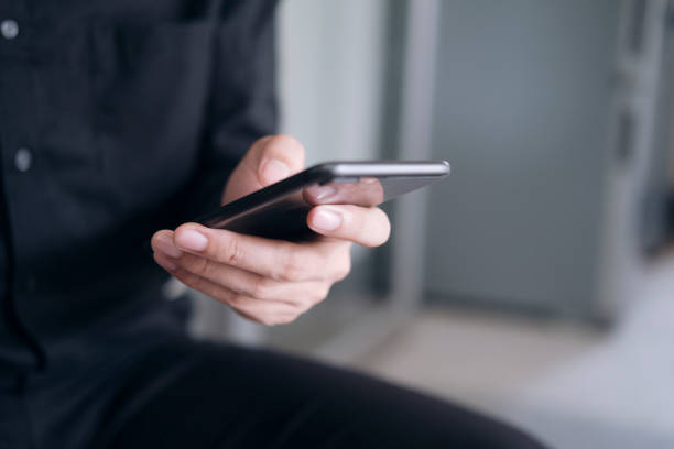 istock Close up of man using mobile phone. 1328543187