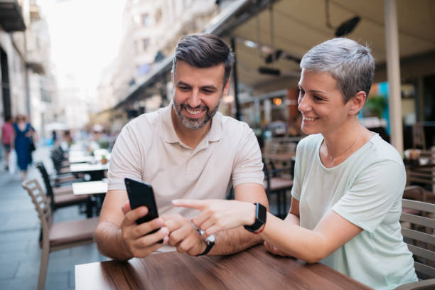 istock Caucasian middle aged couple using a smart phone 1328545846