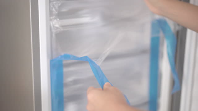 Hands removing the protective film