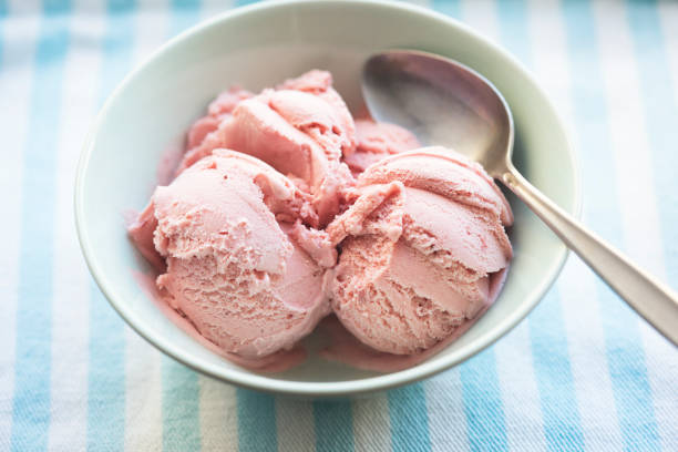 istock Strawberry ice creams scoops in blue bowl 1328549036