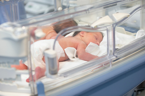 Newborn children are in the boxes in the hospital.