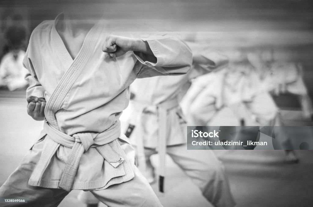 Elbow punch in karate. Children's training. Black and white photo with film grain effect. Karate Stock Photo