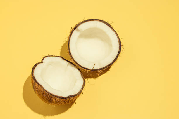 istock Coconut and two halves, on a yellow background, summer 1328551315