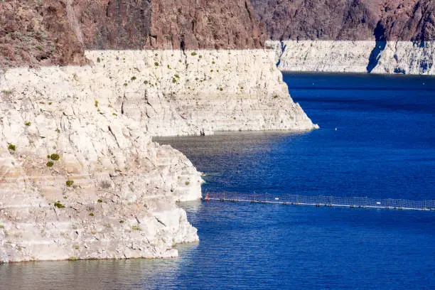 Record low water level of Lake Mead, key reservoir along Colorado River, amid severe drought in the American West. Exposed bathtub ring.