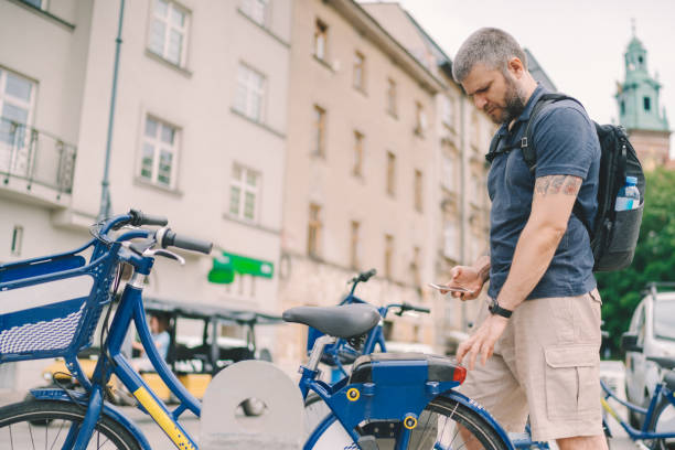 istock Tourist in Krakow renting bicycle via mobile 1328552557