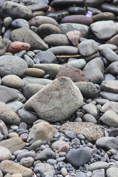 istock Beach stones and pebble texture for industrial background 1328554083