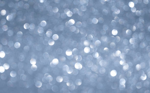 istock gray horizontal background with white glowing bokeh 1328555995