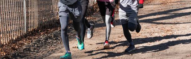 istock Group of boys wearing spandex running uphill on a dirt path 1328556118