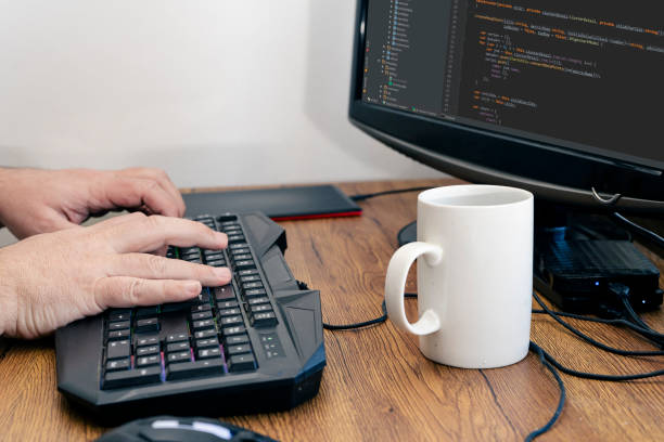 istock View of a man's hands typing on his pc or computer keyboard at his home desk while working. Work at home concept. 1328559714