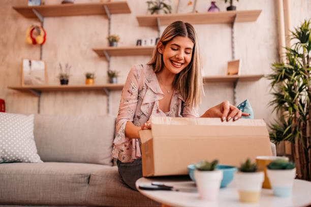 istock Woman customer opening cardboard box parcel 1328560403