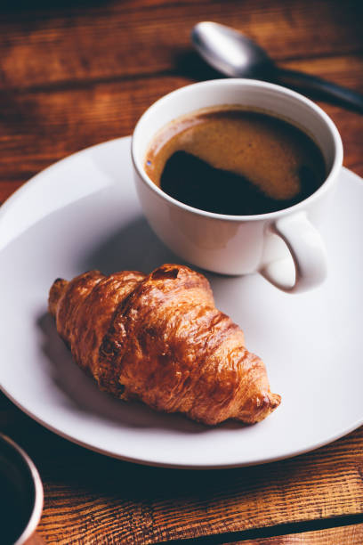 istock Cup of Coffee and Fresh Croissant 1328561656