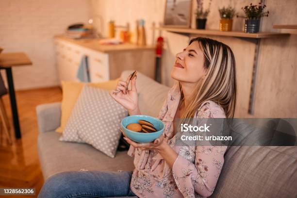 Beautiful Woman Eating Cookies At Home Stock Photo - Download Image Now - Cookie, Eating, Women