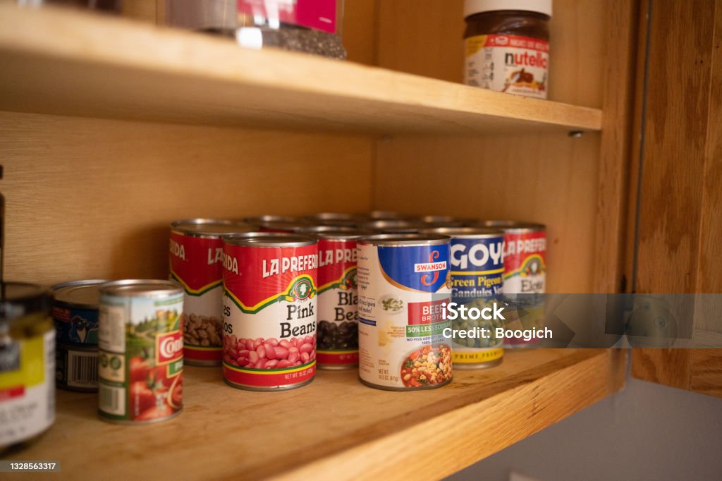 Canned Goods on Kitchen Pantry Shelf This is a still life photograph of canned food on a kitchen pantry shelf in Chicago, USA. Pantry Stock Photo