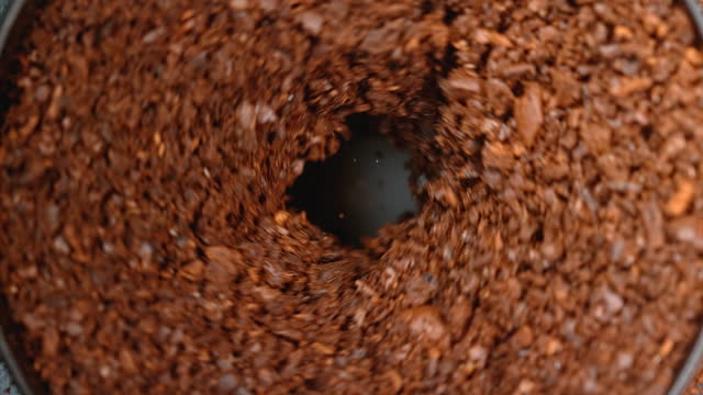 SLO MO LD Coffee beans falling into a coffee grinder