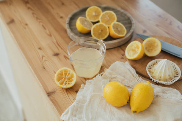 istock Fresh lemonade in the making: fresh lemons, lemon juice and juicer close up. 1328575462