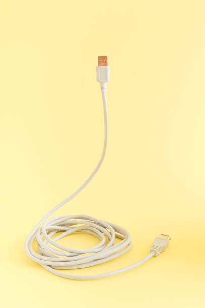 Computer cable for connection on a yellow background. The concept of technology and communication. Minimal composition