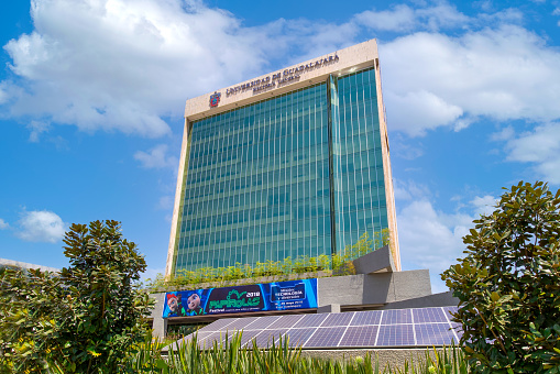 Facade and entrance of new Budget Bureau Bangkok  in Phaya Thai. Seated at 1063 Phahonyothin Rd, Samsen Nai, Phaya Thai, Bangkok . In foreground are thai and royal flag