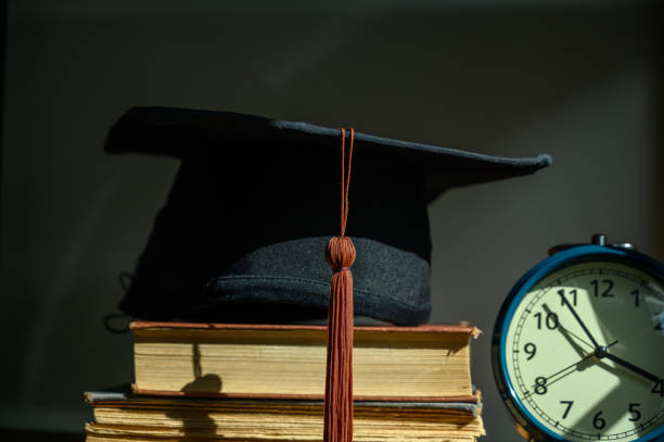 istock the black hat of the graduates put on the book 1328577565
