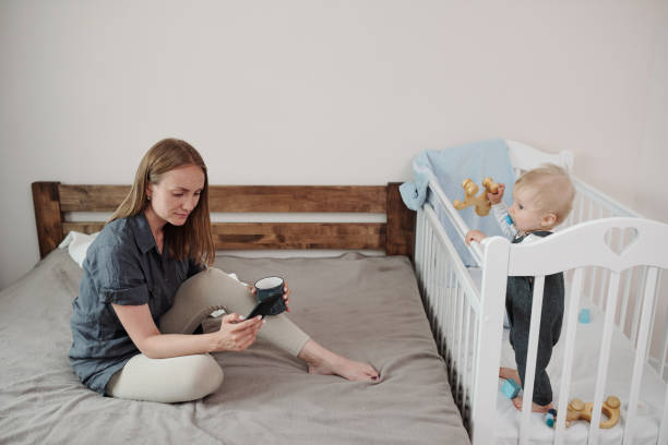 istock Mother Answering Messages Over Coffee 1328579478
